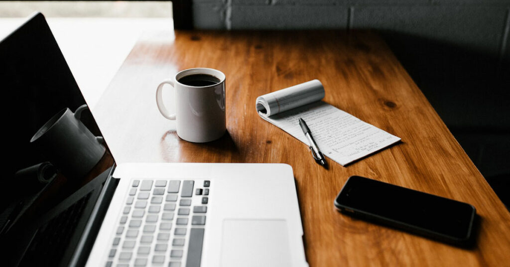 feature image of laptop, coffee, notepad, and phone for use on microsoft teams and workday learning blog